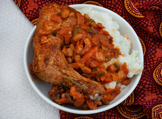 Traditional south African pap and roasted chicken, maize meal with chicken piece and chakalaka sauce
