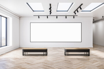 Big blank white poster in black frame on light wall in empty gallery area with windows and spotlights in the ceiling, wooden parquet floor and two stylish benches. 3D rendering, mockup