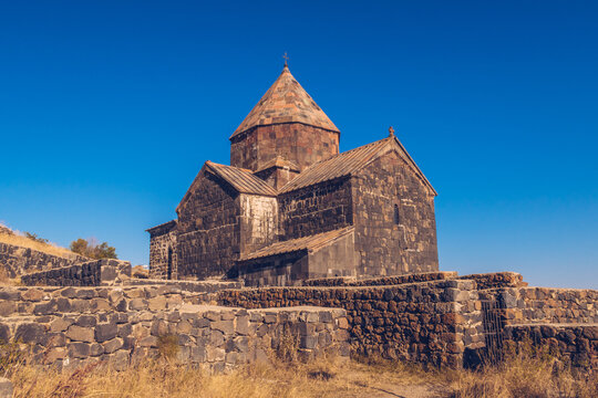 Scenic view of an old Sevanavank church in Sevan. Blue sky and bright autum colors on the sunny day. Ancient temple stock photography.