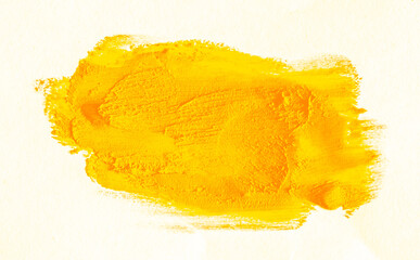 Smear of yellow paint on a white background. Cosmetics, makeup. Isolated template for design. Golden