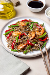 Soba noodles with shrimp, pepper and green beans. Japanese cuisine. Asian food.