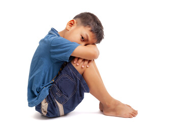  sad boy sittign on white background