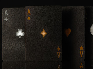 Obraz premium 3D image. Poker black cards, three aces on a black background. Casino, nightclub, gambling, poker, gambling business, game strategy. Advertising, banner. There are no people in the photo.