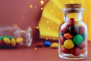 Milk chocolate bonbons in shell with on bordo color background with bokeh. Magical background with bonbons.