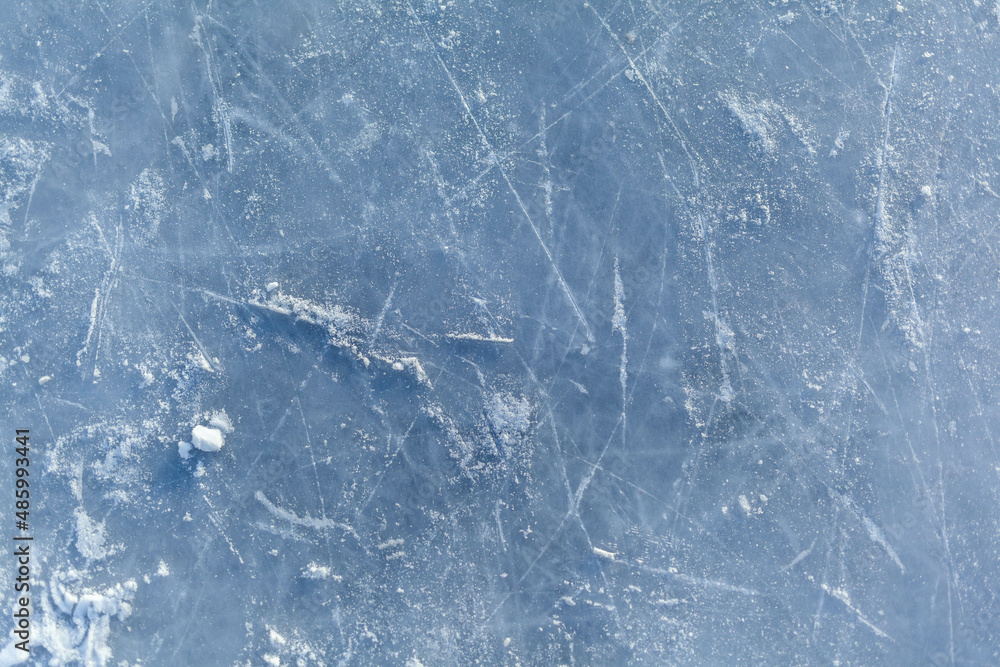 Poster empty ice rink with skate marks after the session outdoor. skating ice rink texture covered with sno