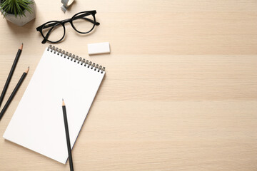 Fototapeta premium Flat lay composition with blank sketchbook on wooden table. Space for text