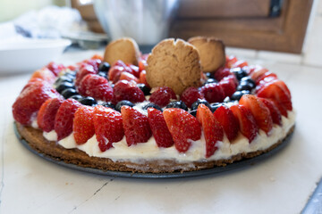 Tart with strawberry, raspberry, blueberry and whipped cream