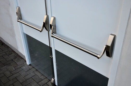 rear door of department store or warehouse with handle for quick release of door. evacuation door handle, panic fire button. in dangerous crush, all you have to do is lean horizontal pushing, push,