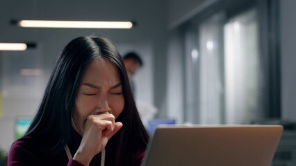 Exhausted asian businesswoman yawn working late in office. 