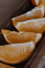 Orange in wooden basket on light background