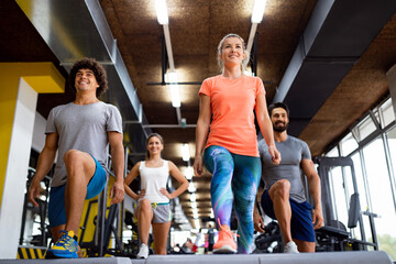 Portrait of happy fit group of people working out in gym together