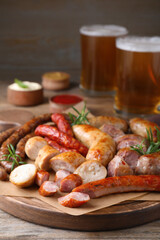 Set of different tasty snacks on wooden table, closeup view