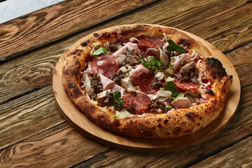Meat Italian pizza with roast beef, steak slices, melted cheese, with olive slices and cheddar cheese. Close up, macro. Pizza time concept.