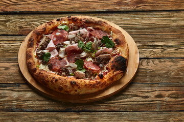 Meat Italian pizza with roast beef, steak slices, melted cheese, with olive slices and cheddar cheese. Close up, macro. Pizza time concept.