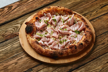 Meat Italian pizza with roast beef, steak slices, melted cheese, with olive slices and cheddar cheese. Close up, macro. Pizza time concept.
