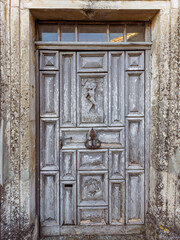 Antique carved wooden door in a medieval village in the South of France