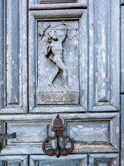 Detail of an old medieval carved wooden door