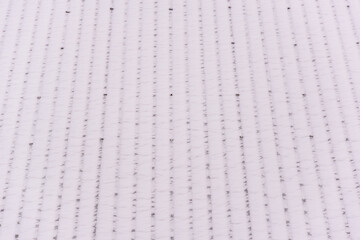 There is fluffy snow on the roof of the house.