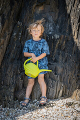 Portrait of little boy leaning on cliff