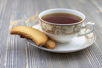 Homemade cookies on a saucer with a cup.
