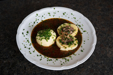 cooking at home and ready to eat, greaves dumpling in brown sauce from a roasted venison and chives