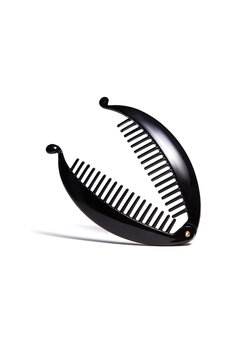 recommend clip art: Detailed shot of a black banana hair clip. The hairpin is isolated on the white background. Vogue accessory for ladies and girls.