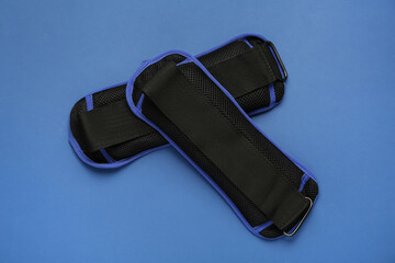 Stylish weighting agents on blue background, flat lay