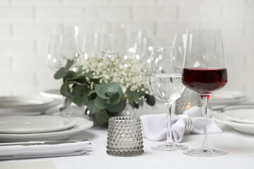 Glass of delicious wine and elegant table setting in restaurant