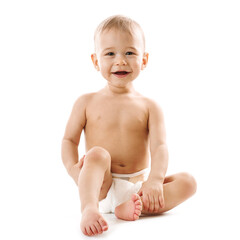 Curious healthy little boy in diaper sitting and laughling.