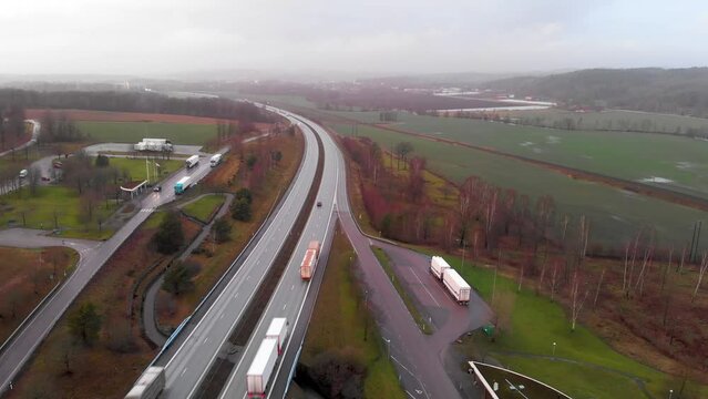 Aerial drone footage of Rest Area North of Halmstad, Sweden on European route E6 thoroughfare highway system on cloudy and slightly foggy day