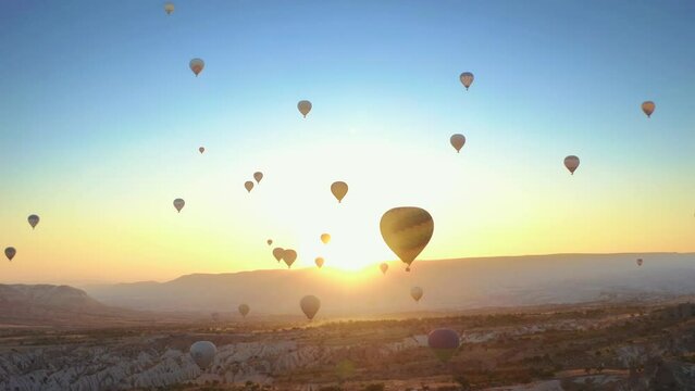Aerial drone view of colorful hot air balloon flying over Cappadocia at summer sunrise. 4K. 3