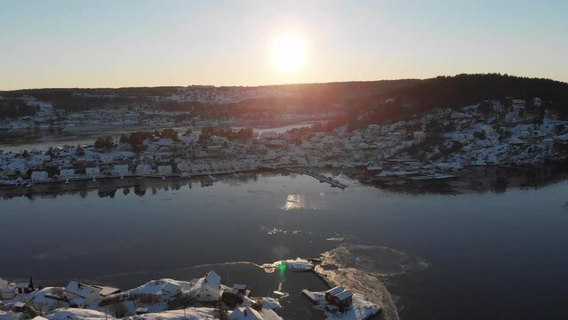 Winter Sunrise Over Snowy Kragero City In Vestfold og Telemark, Norway. wide aerial drone