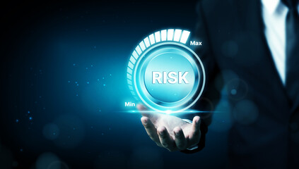Risk management business strategy planning concept. Businessman hand holding risk level