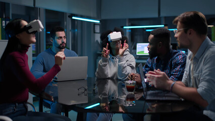 Multiethnic start-up team having meeting wearing vr goggles. 