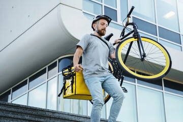 Express delivery courier with insulated bag carrying bicycle.