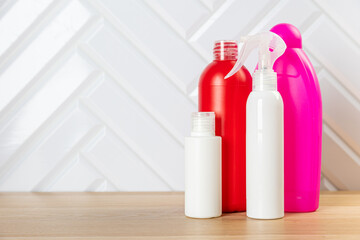 Cleaning bottles for different surfaces in kitchen, bathroom and other rooms. close up. top view. wide banner. Empty place for text or logo.