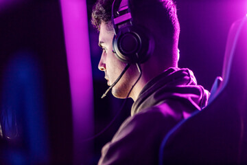 Rear view of professional gamer with headset playing video game. © Dusan Petkovic