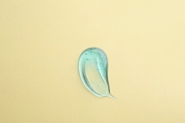 Smear of ointment on beige background, top view
