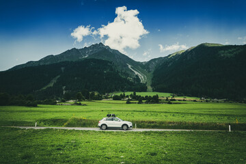 Car travelling on road against mountain