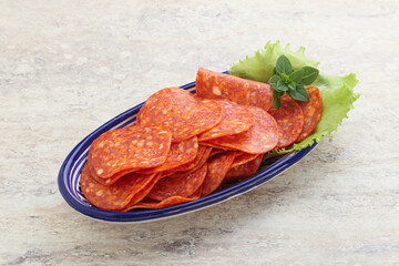 Sliced pepperoni sausage in the bowl