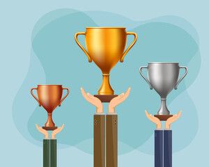 Winners athletes hold gold, silver and bronze cups