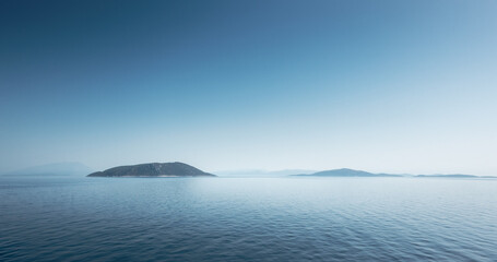 View of ocean and silhouette of mountain