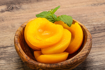 Sweet ripe canned peaches with mint