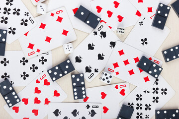 Dominoes, playing cards and dice for board games on table. View from above.