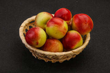 Sweet small nectarines in the basket
