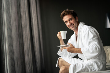 Handsome man in bathrobe relaxing at spa wellness hotel - obrazy, fototapety, plakaty