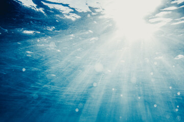 Clear blue water in ocean with sunbeams