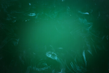 Fototapeta premium Dirty green chalkboard as background. Vignette effect