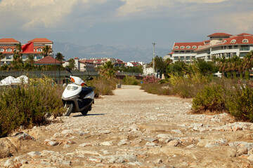 Scooter on rocky road in turkey on the shores of the mediterranean sea
