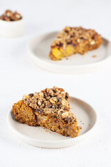 Pieces of homemade cake with walnuts on plates. Healthy food, sugar, gluten and lactose free, vegan.